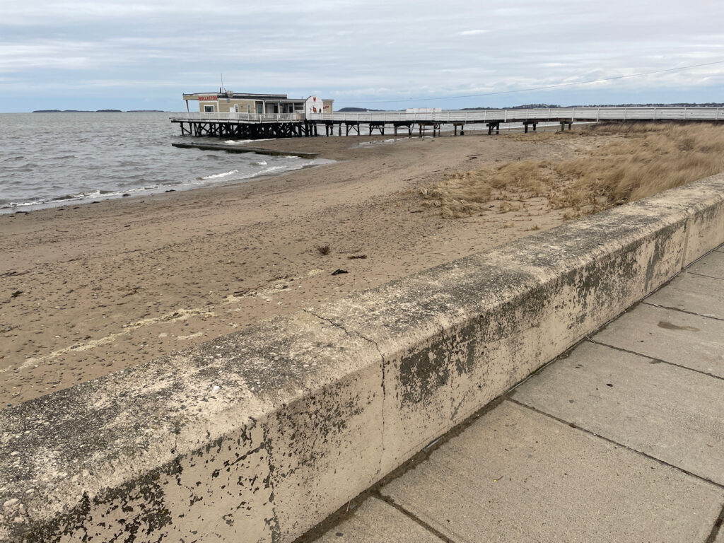 a concrete wall next to a beach (MyCoast AI)