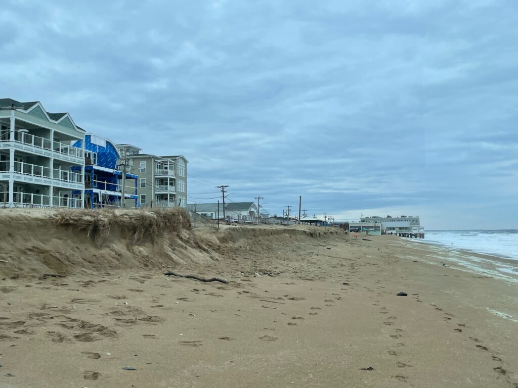 a sandy beach with buildings on the side (MyCoast AI)