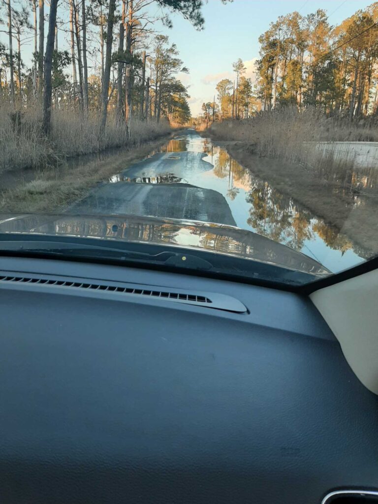 a car driving on a wet road (MyCoast AI)