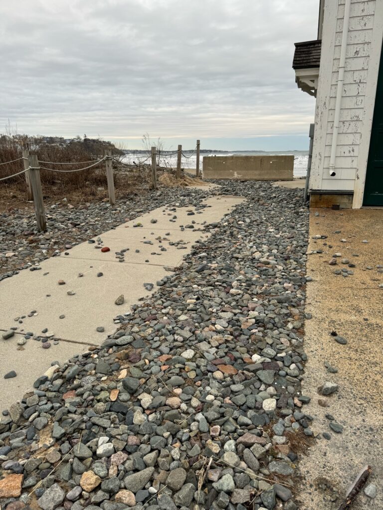 a rocky beach with a fence (MyCoast AI)