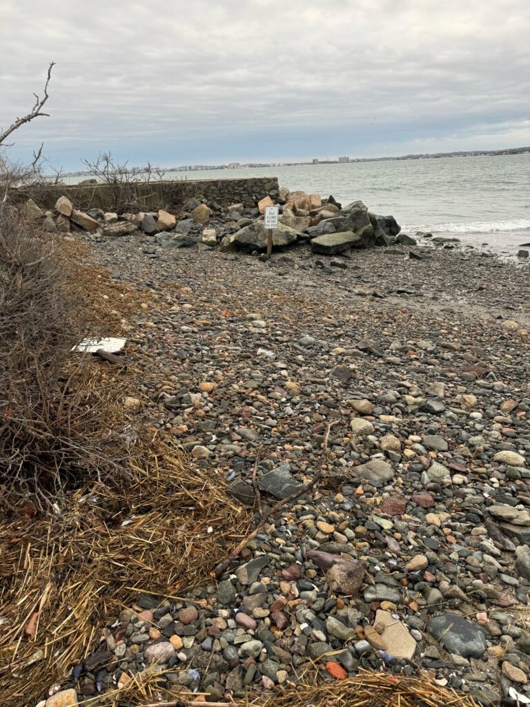 a rocky beach with a sign (MyCoast AI)