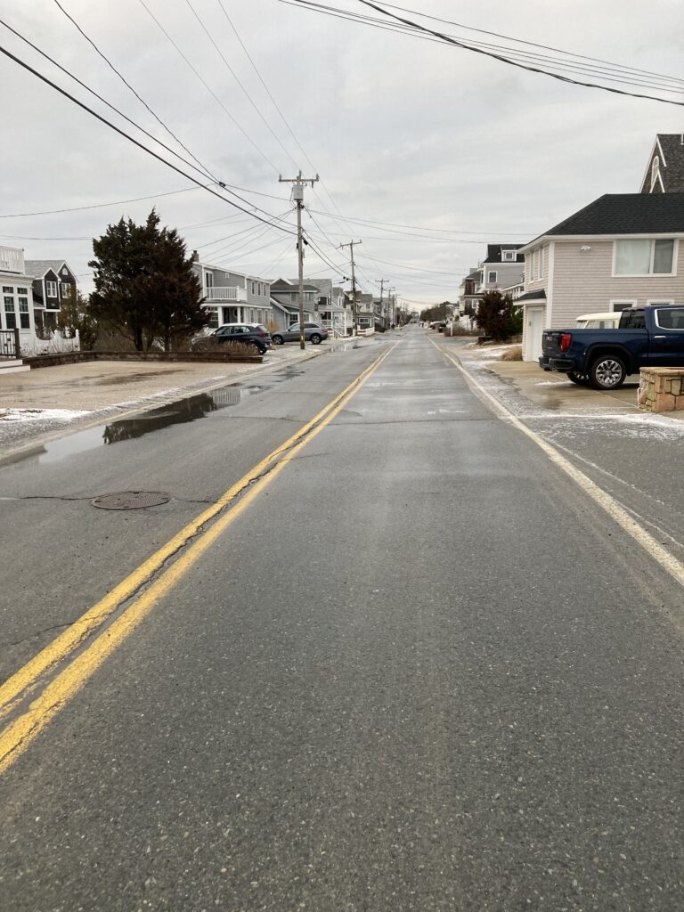 a street with cars parked along it (MyCoast AI)