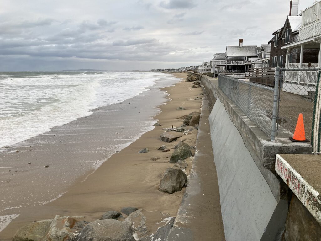 a beach with rocks and a fence (MyCoast AI)