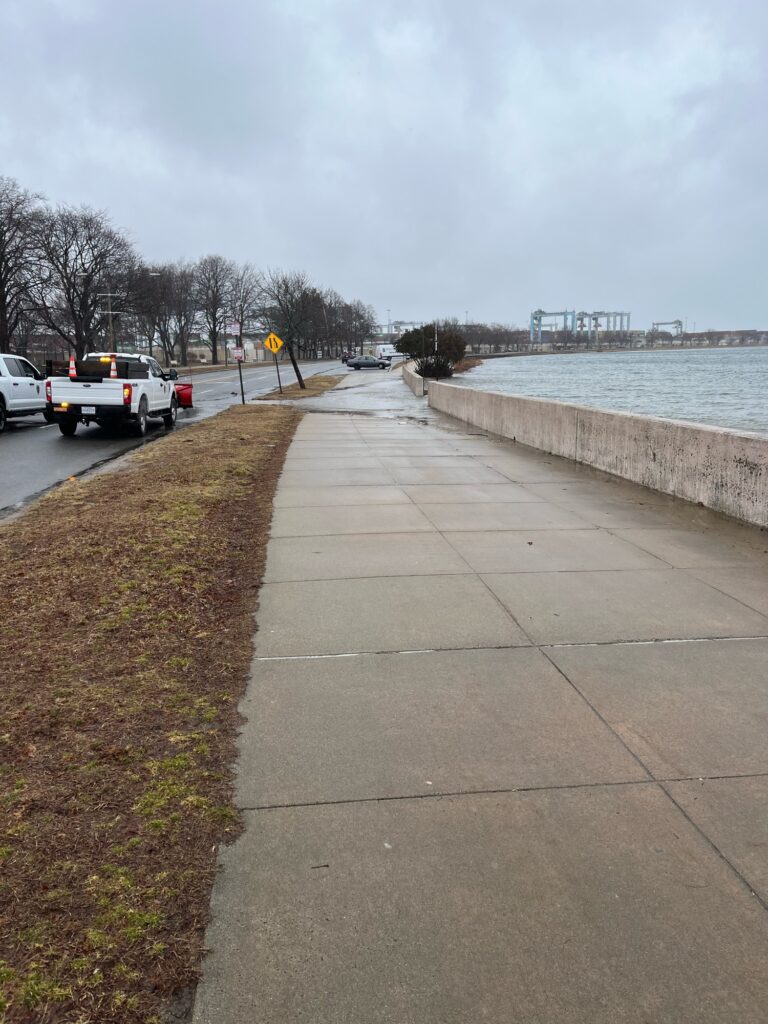 a sidewalk with cars parked along it (MyCoast AI)