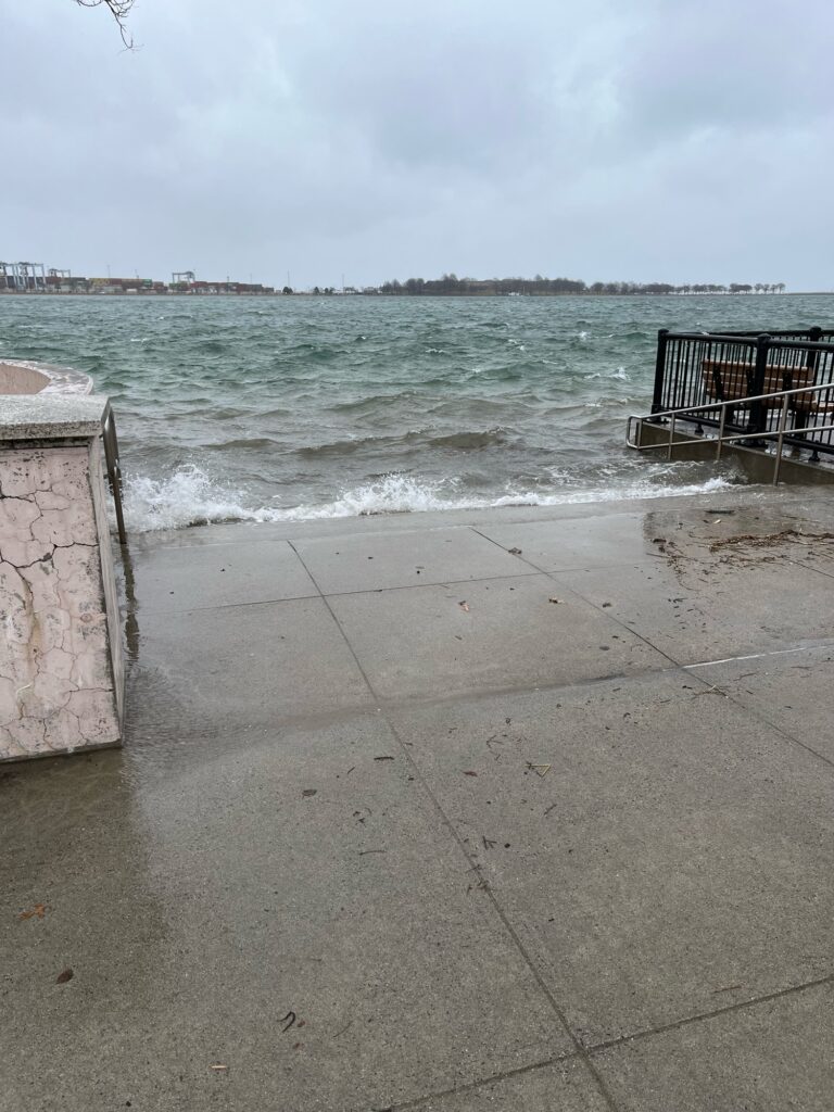 a concrete walkway next to a body of water (MyCoast AI)