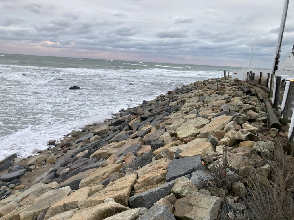 a rocky beach with a fence (MyCoast AI)