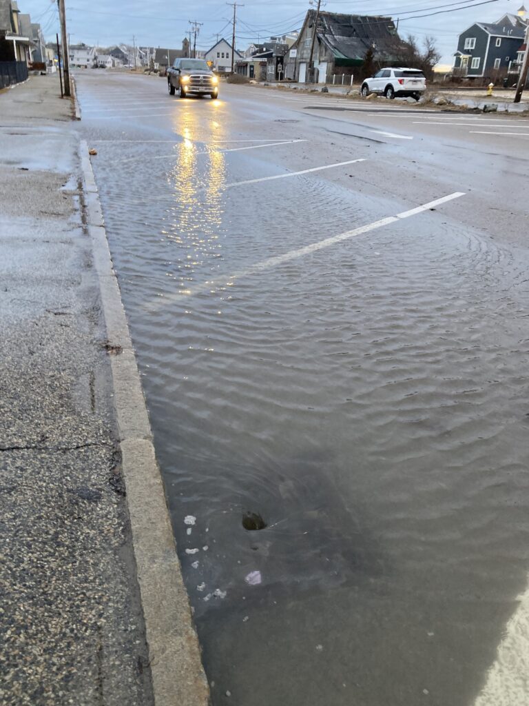 a wet road with cars on it (MyCoast AI)