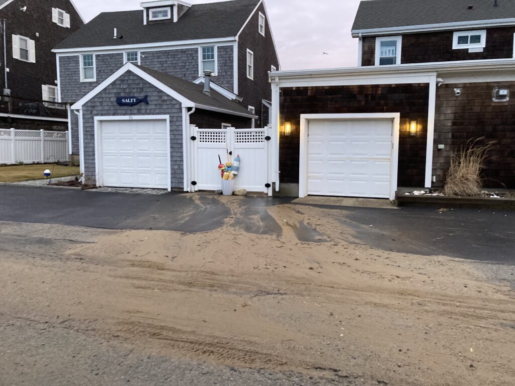 a driveway with garages and a house in the background (MyCoast AI)