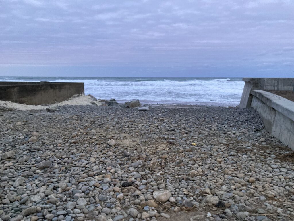 a rocky beach with a pier (MyCoast AI)