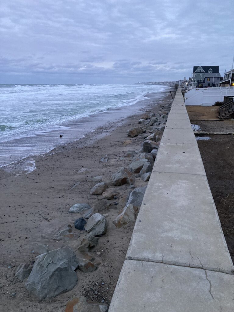 a concrete walkway next to a body of water (MyCoast AI)