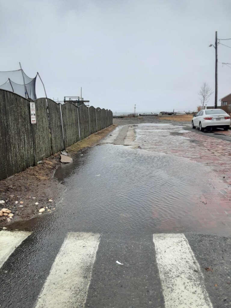 a road with a car on it and a fence on the side (MyCoast AI)