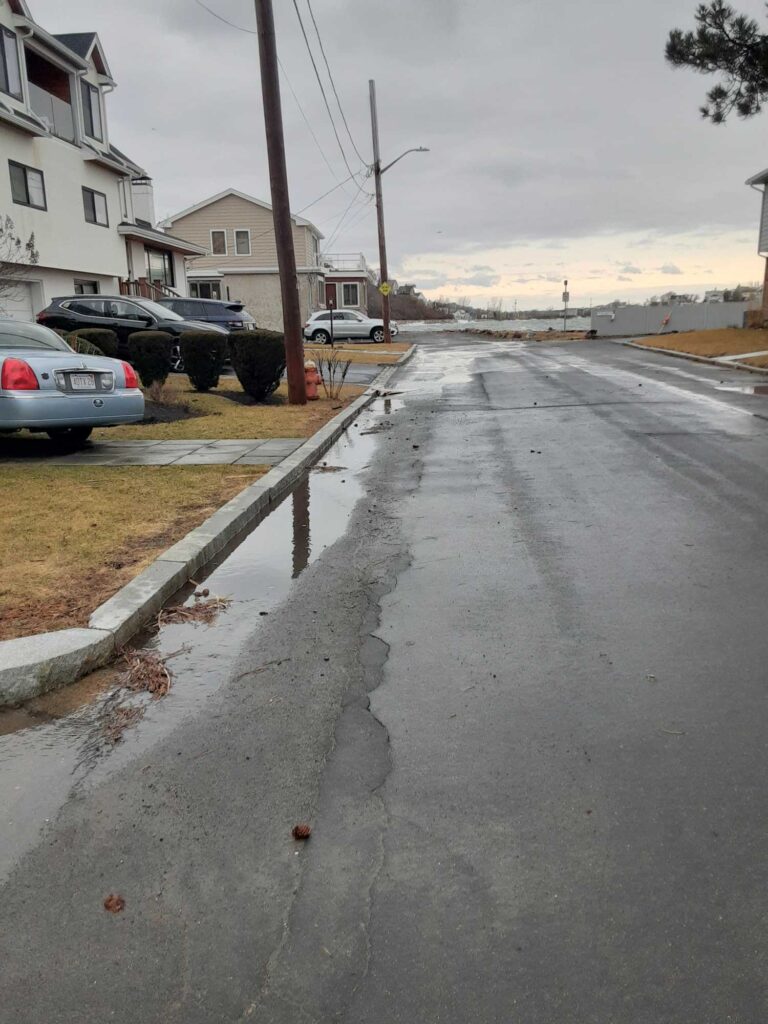 a street with cars parked along it (MyCoast AI)