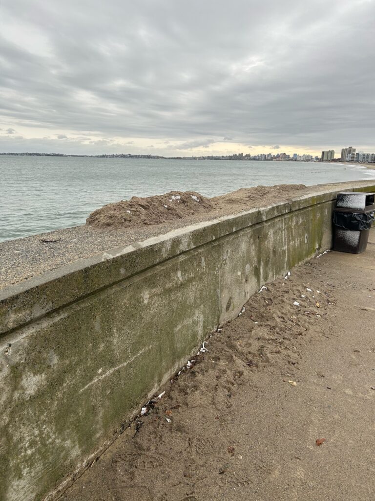 a concrete wall next to a body of water (MyCoast AI)