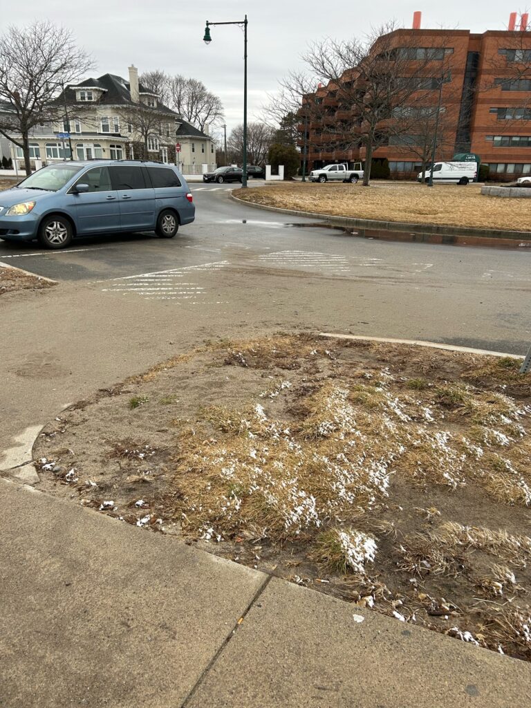 a road with a puddle on the side and cars on the side (MyCoast AI)