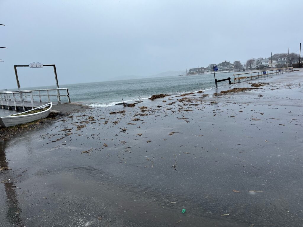 a beach with a pier and boats (MyCoast AI)