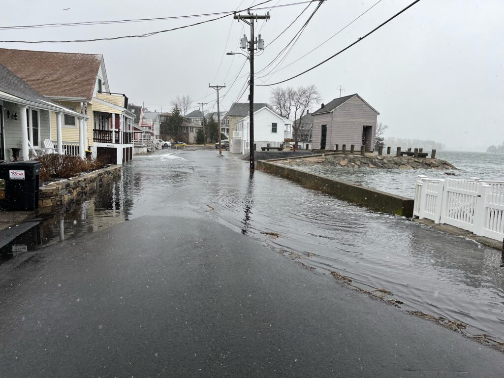 a flooded street with houses and power lines (MyCoast AI)