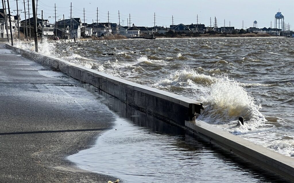 a body of water with waves crashing against a concrete wall (MyCoast AI)