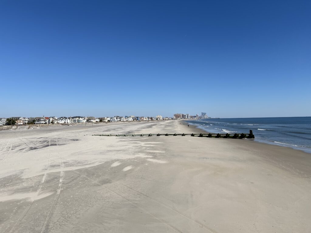 a sandy beach with buildings in the background (MyCoast AI)