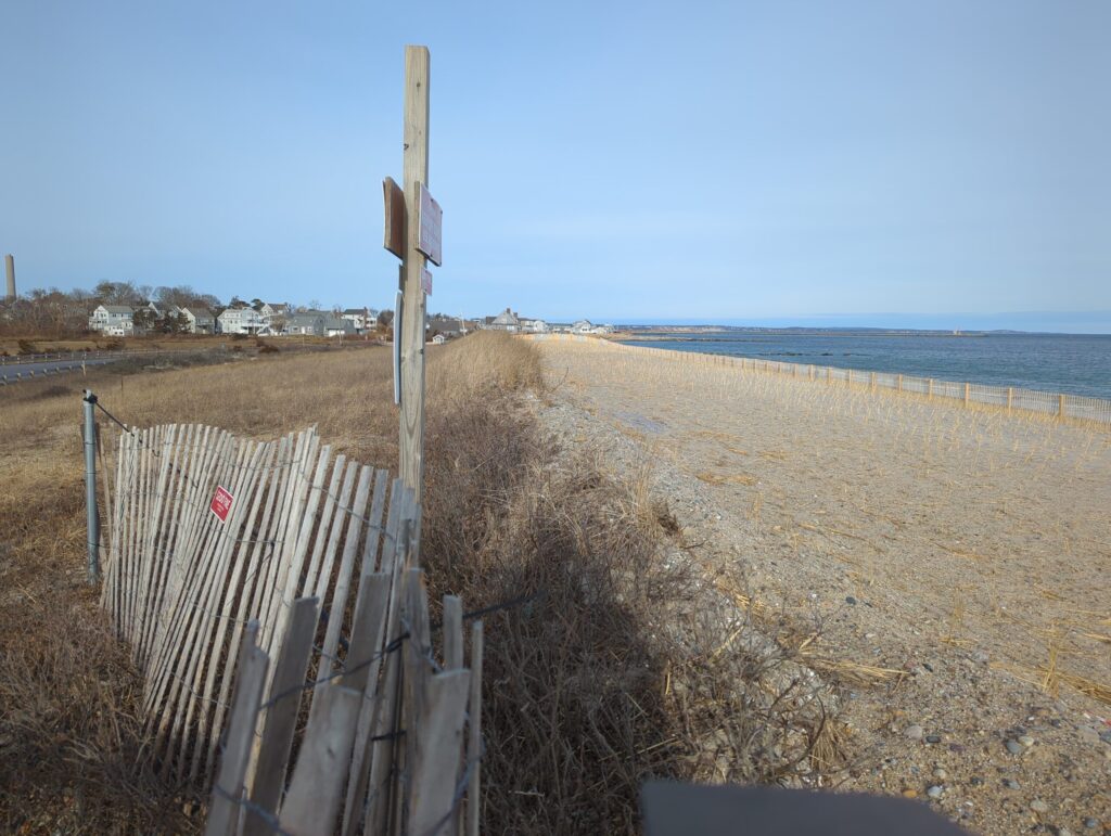 a wooden fence on a beach (MyCoast AI)