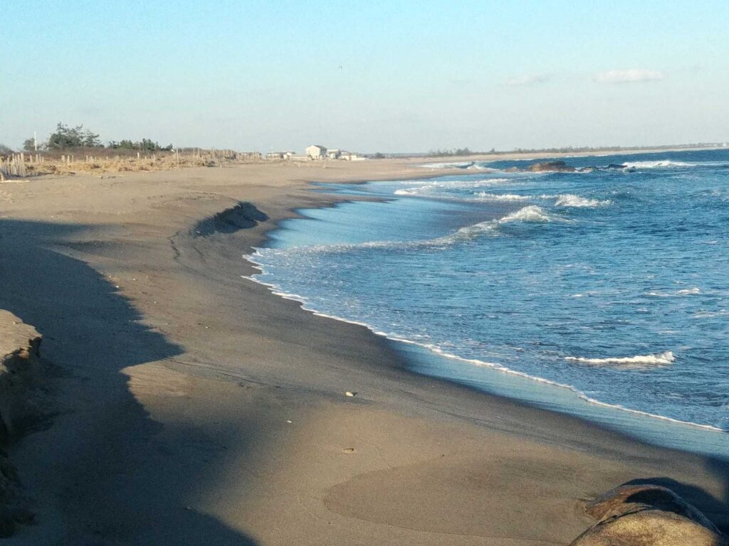a beach with waves crashing on it (MyCoast AI)