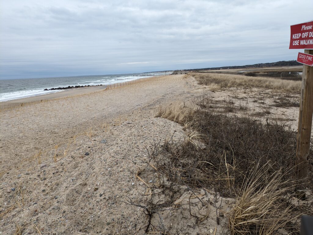 a sandy beach with a sign (MyCoast AI)