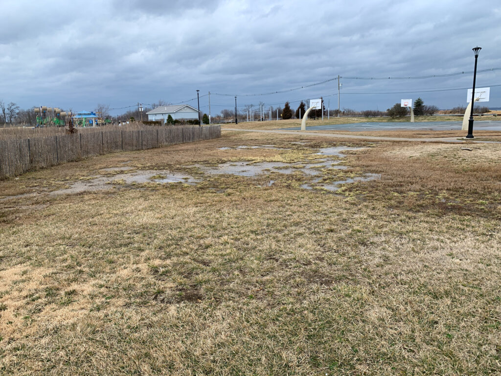 a field with a puddle (MyCoast AI)