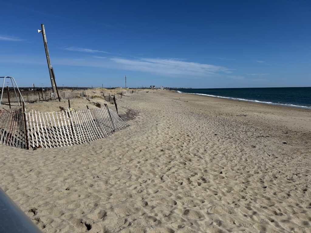 a beach with a fence and a structure on it (MyCoast AI)