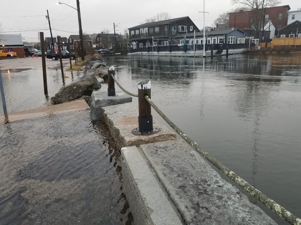 a flooded street with a fire hydrant (MyCoast AI)