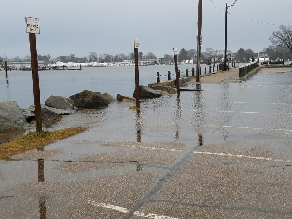 a flooded road with a few people (MyCoast AI)