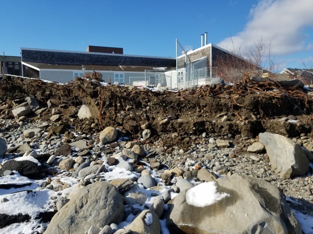 a building with a lot of rocks in front of it (MyCoast AI)