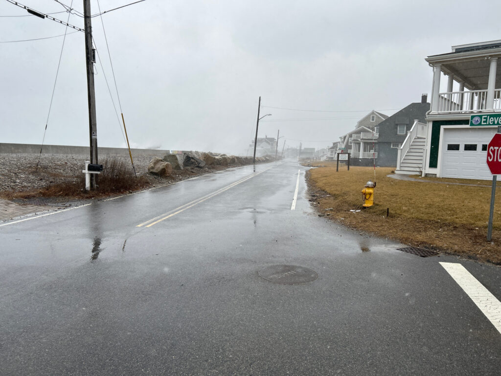 a wet road with a yellow fire hydrant (MyCoast AI)