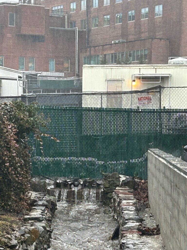 a fenced in area with a building in the background (MyCoast AI)