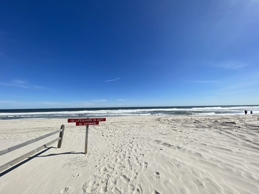 a sign on a beach (MyCoast AI)