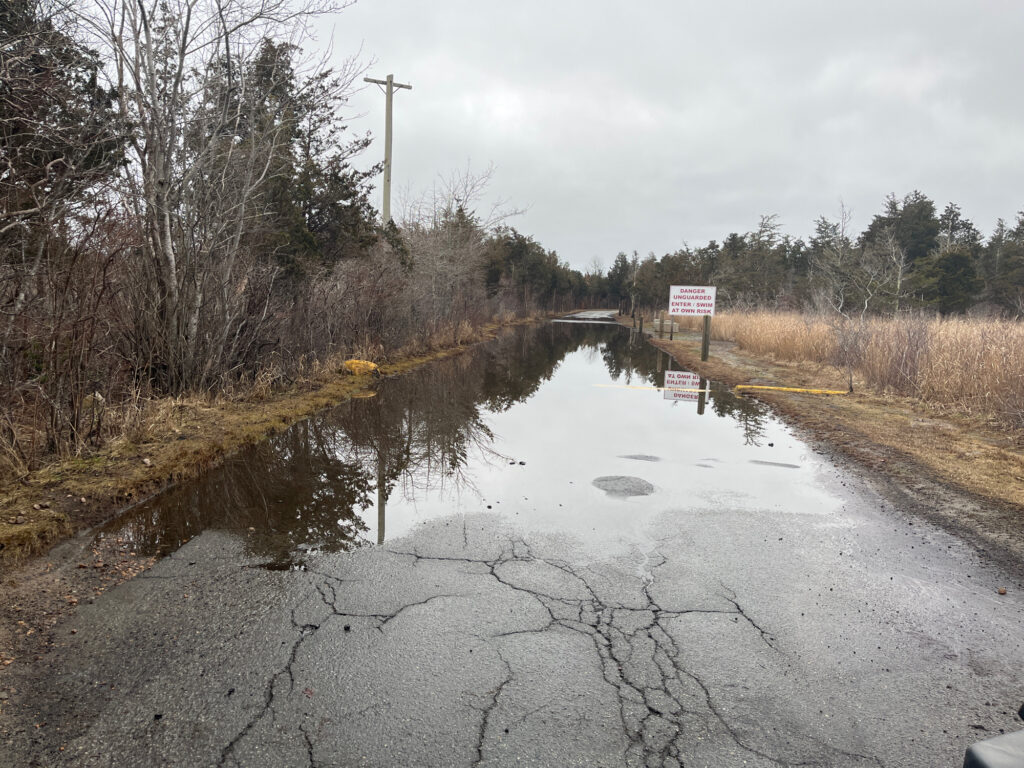 a flooded road with a sign (MyCoast AI)