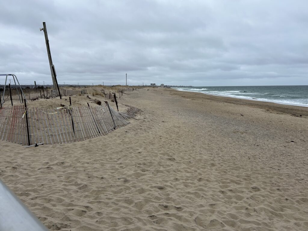 a sandy beach with a fence (MyCoast AI)