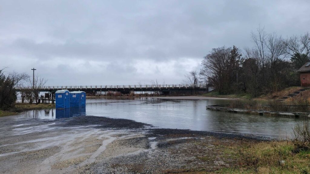 a body of water with a bridge and trees around it (MyCoast AI)