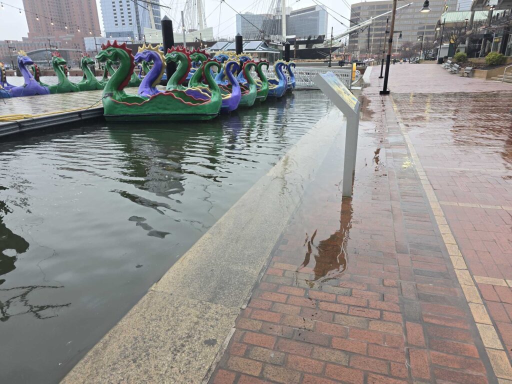 a brick walkway with a brick walkway and boats in the water (MyCoast AI)