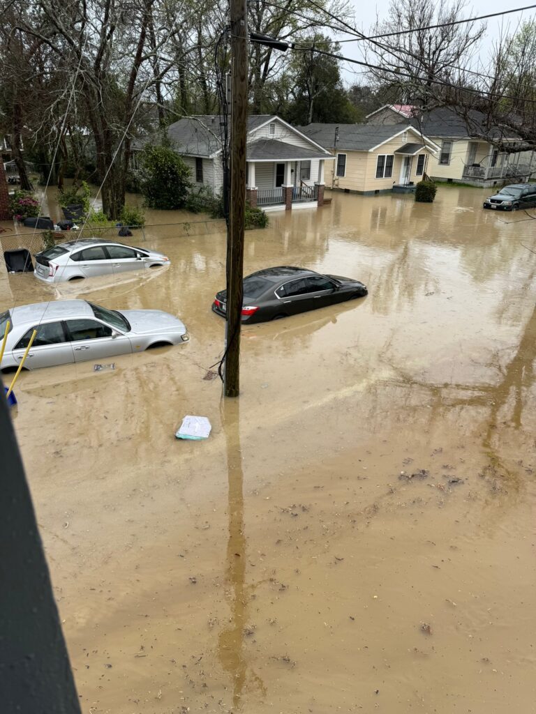 a flooded street with cars and houses (MyCoast AI)