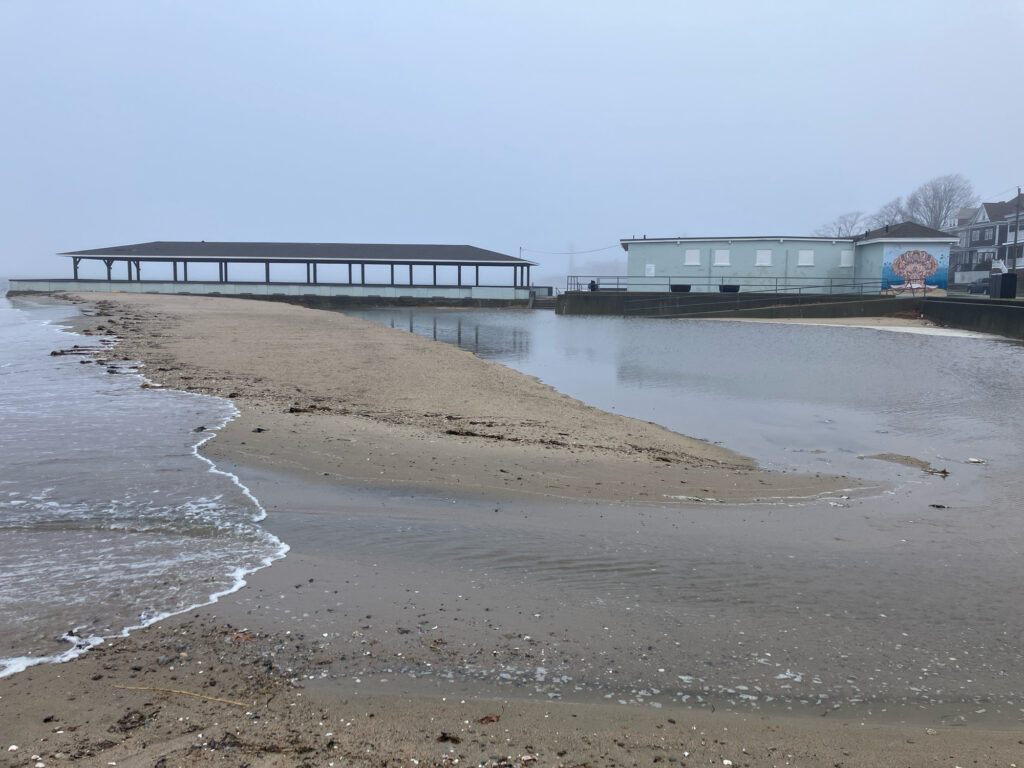 a beach with a pier and buildings (MyCoast AI)