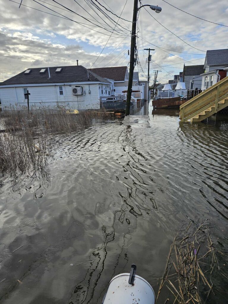 a flooded area with houses and power lines (MyCoast AI)