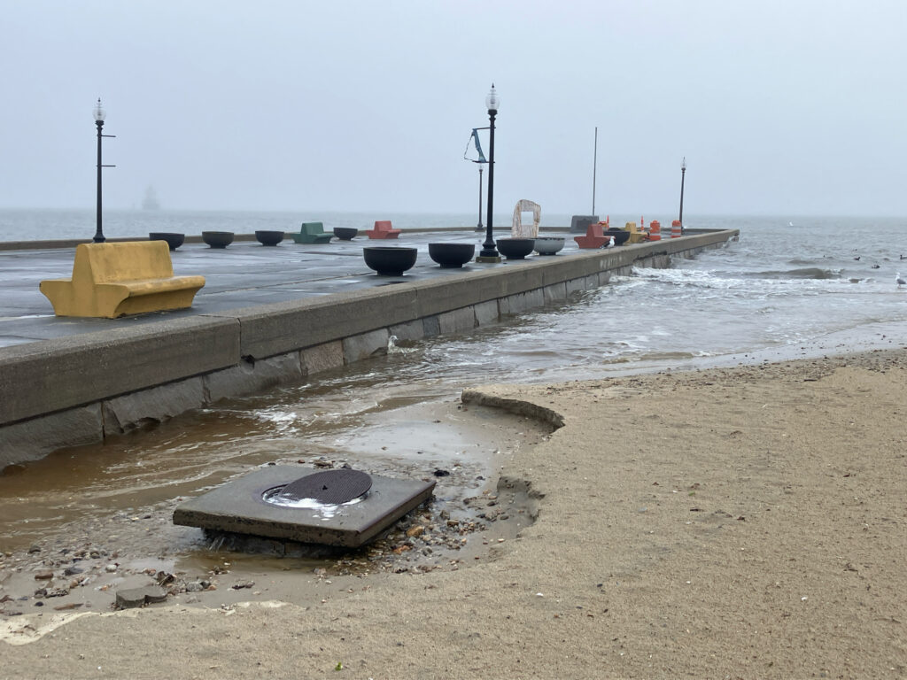 a concrete dock with a concrete walkway and a body of water (MyCoast AI)