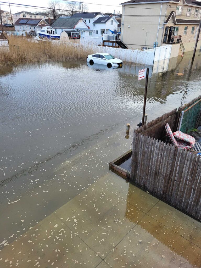 a flooded street with a car parked on the side (MyCoast AI)