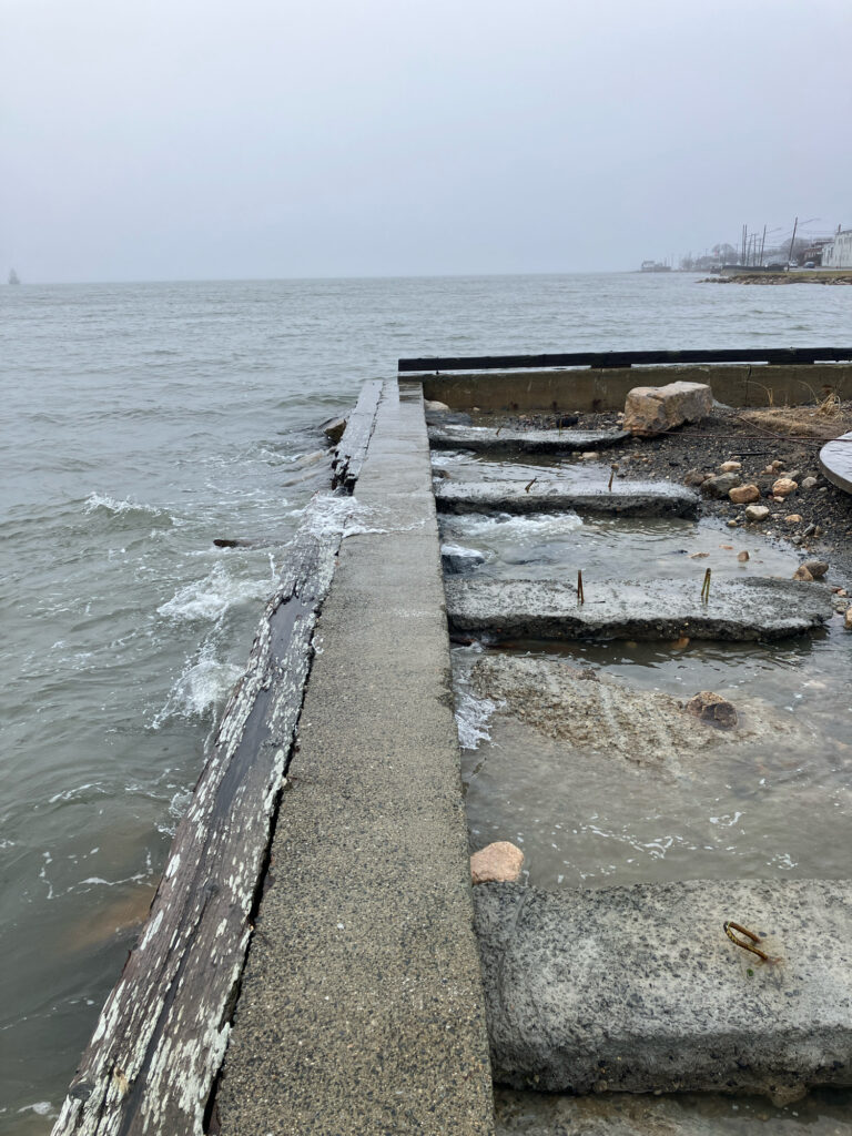 a body of water with rocks and a dock (MyCoast AI)
