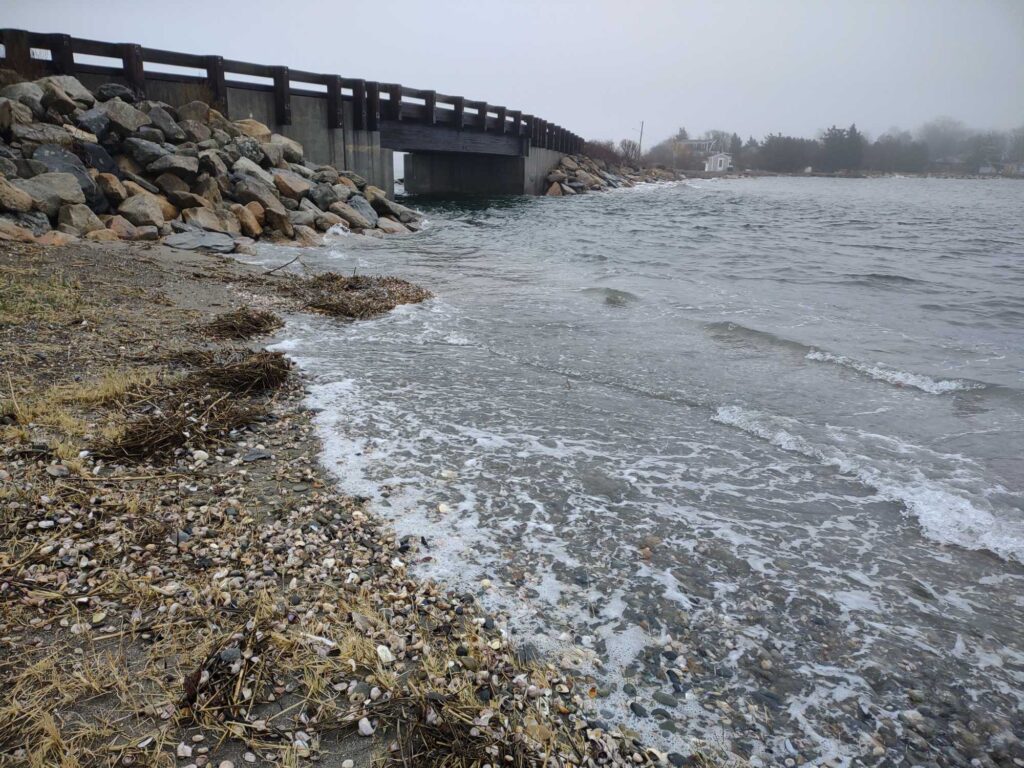 a rocky beach with a bridge (MyCoast AI)