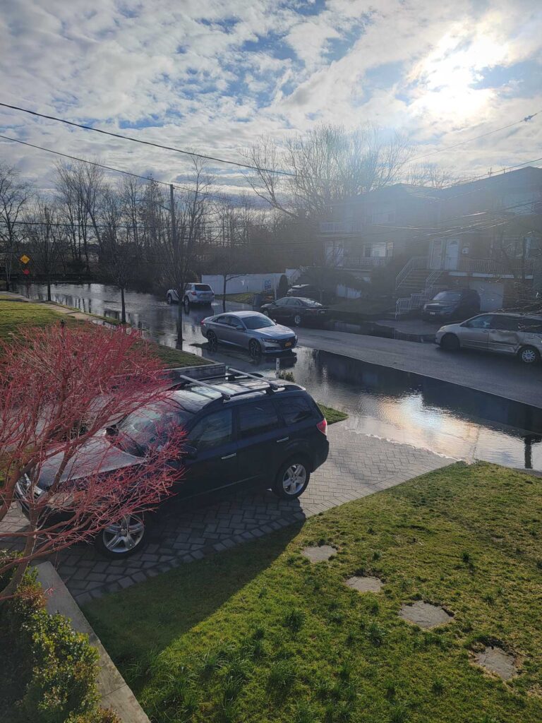 a car parked on the side of a road with a puddle of water (MyCoast AI)