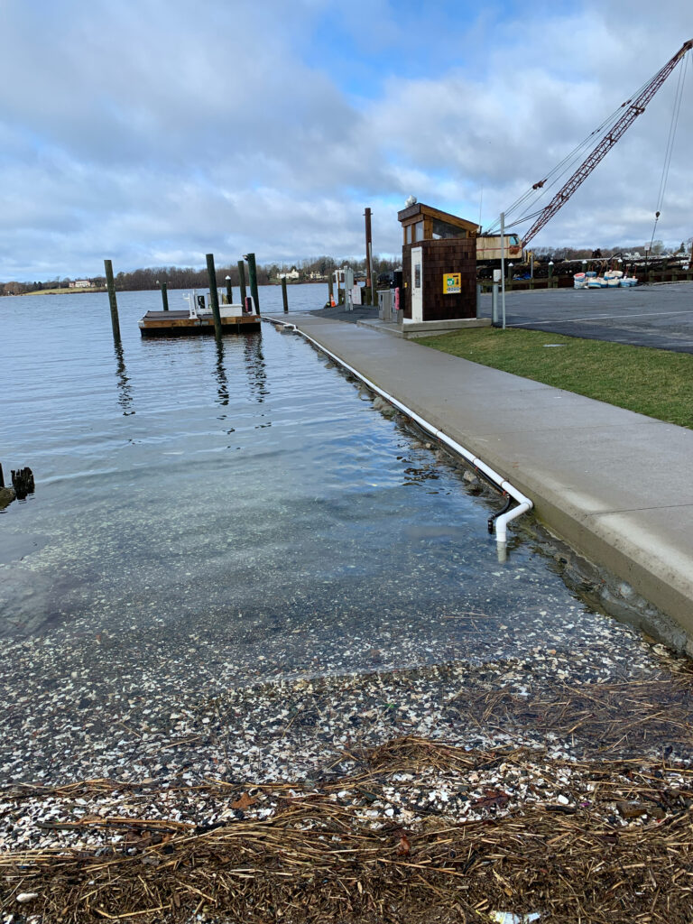 a body of water with a crane and a building in the background (MyCoast AI)