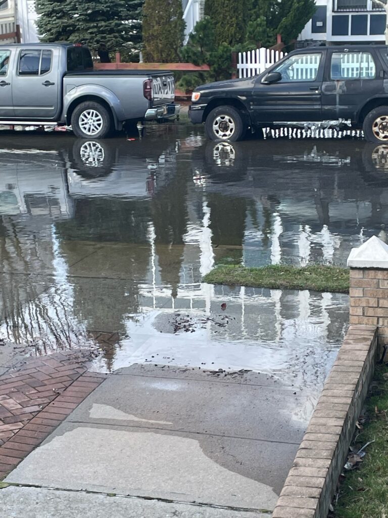 a flooded street with cars parked (MyCoast AI)