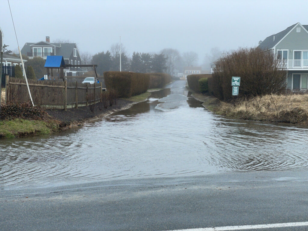 a flooded road with houses on either side of it (MyCoast AI)