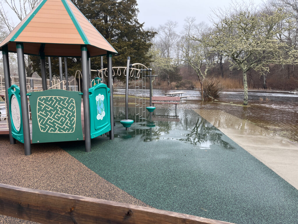 a flooded area with a shelter and a sign (MyCoast AI)
