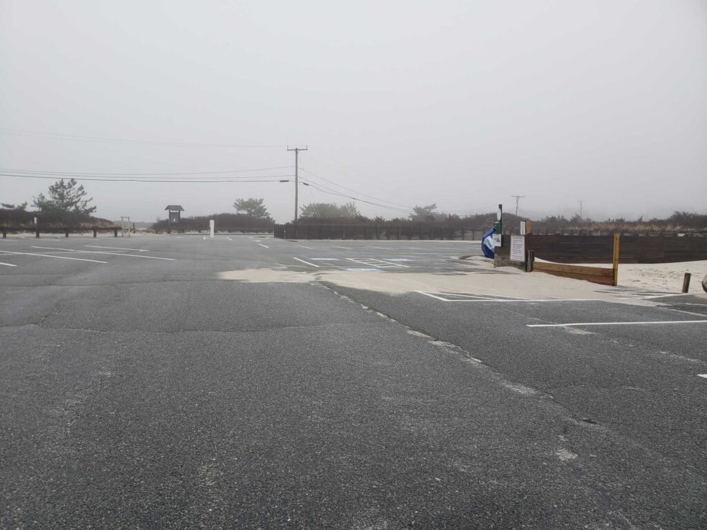 a road with a puddle on the side (MyCoast AI)